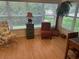 Bright living room features large windows, hardwood floors, and elegant furnishings at 725 Beldon Ct, The Villages, FL 32162