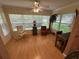 Bright sunroom featuring hardwood floors, large windows, and comfortable seating at 725 Beldon Ct, The Villages, FL 32162