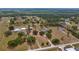 Sprawling property with mature trees, a home, and long driveways, showcased in an aerial view at 7973 Lake Nellie Rd, Clermont, FL 34714