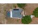 Aerial view showcasing a spacious home with a pool, patio, driveway, and lush landscaping at 7973 Lake Nellie Rd, Clermont, FL 34714