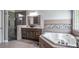 Bathroom with a soaking tub, walk-in shower, dual sinks, and elegant tile at 7973 Lake Nellie Rd, Clermont, FL 34714