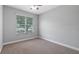 Cozy bedroom with a large window and plush carpet, perfect for relaxing at 7973 Lake Nellie Rd, Clermont, FL 34714