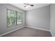 Cozy bedroom with a large window and plush carpet, perfect for relaxing at 7973 Lake Nellie Rd, Clermont, FL 34714