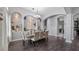 Elegant dining room featuring a stylish chandelier, hardwood floors and decorative wall arches at 7973 Lake Nellie Rd, Clermont, FL 34714