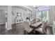 Elegant dining room with wood floors, ample seating, and a decorative chandelier fixture at 7973 Lake Nellie Rd, Clermont, FL 34714
