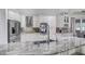 Stunning kitchen features granite countertops and stainless steel appliances with custom cabinetry at 7973 Lake Nellie Rd, Clermont, FL 34714