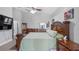 Well-lit main bedroom showcasing a wooden bed frame and ensuite bathroom at 7973 Lake Nellie Rd, Clermont, FL 34714