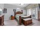 Spacious main bedroom with a large wooden bed frame, high ceilings, and natural light at 7973 Lake Nellie Rd, Clermont, FL 34714