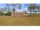 A spacious outbuilding with dual entries offers ample storage and workspace with easy backyard access at 7973 Lake Nellie Rd, Clermont, FL 34714