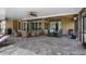 Large patio with comfortable outdoor seating and multiple entry points to the house at 7973 Lake Nellie Rd, Clermont, FL 34714