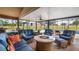 Covered patio area with stylish outdoor seating and a fire pit at 7973 Lake Nellie Rd, Clermont, FL 34714