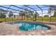 Enjoy the outdoors while relaxing in this covered screened in pool with brick surround at 7973 Lake Nellie Rd, Clermont, FL 34714