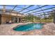 A beautiful pool and spa area with covered patio, lounge chairs, and outdoor dining for relaxation and entertainment at 7973 Lake Nellie Rd, Clermont, FL 34714