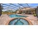 A sparkling pool and hot tub are surrounded by a screened enclosure and brick patio, perfect for outdoor fun at 7973 Lake Nellie Rd, Clermont, FL 34714