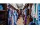 Walk-in closet with clothing racks and shelving units on either side for optimal storage at 7973 Lake Nellie Rd, Clermont, FL 34714