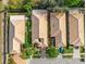 Aerial shot of a neighborhood featuring well-maintained homes with tile roofs and lush landscaping at 9027 Saint Andrews Way, Mount Dora, FL 32757