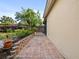 Beautiful backyard with a brick paver pathway and colorful landscaping at 9027 Saint Andrews Way, Mount Dora, FL 32757