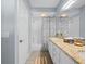 Well-lit bathroom with granite countertops, white cabinets, a separate shower, and decorative accents at 9027 Saint Andrews Way, Mount Dora, FL 32757