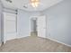 Spacious bedroom with closet space and wood-look tile flooring at 9027 Saint Andrews Way, Mount Dora, FL 32757