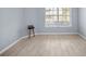 Bedroom with a large window and wood-look tile flooring at 9027 Saint Andrews Way, Mount Dora, FL 32757