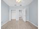 Open bedroom features closet space and wood-look tile flooring at 9027 Saint Andrews Way, Mount Dora, FL 32757