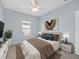 This bedroom offers a ceiling fan, decorative art, and a comfortable layout for relaxation at 9027 Saint Andrews Way, Mount Dora, FL 32757