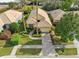 Charming single-Gathering home with a well-manicured lawn, mature landscaping, and a tile roof at 9027 Saint Andrews Way, Mount Dora, FL 32757