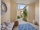 Covered entryway featuring bench seating, decorative rug, and lush landscaping at 9027 Saint Andrews Way, Mount Dora, FL 32757