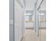 Hallway leading to a well-lit bathroom with dual sinks, granite countertops, and a separate shower at 9027 Saint Andrews Way, Mount Dora, FL 32757
