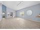 Bright, spacious living room boasts wood-look tile flooring, high ceilings, and natural light at 9027 Saint Andrews Way, Mount Dora, FL 32757