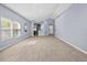 Bright, spacious living room boasts wood-look tile flooring, high ceilings, and natural light at 9027 Saint Andrews Way, Mount Dora, FL 32757