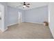 Spacious main bedroom offering tile flooring, an ensuite bathroom, a ceiling fan, and ample space at 9027 Saint Andrews Way, Mount Dora, FL 32757