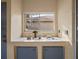 Outdoor sink area featuring a tiled countertop and storage cabinets at 9027 Saint Andrews Way, Mount Dora, FL 32757