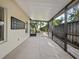 Spacious screened patio with a tranquil view of the surrounding landscape at 9027 Saint Andrews Way, Mount Dora, FL 32757