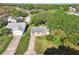 Aerial view of a well-maintained single-Gathering home in a lush, green neighborhood at 915 Sutherland Ct, Leesburg, FL 34788