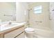 Bathroom features a shower-tub combo and neutral tile at 915 Sutherland Ct, Leesburg, FL 34788