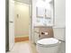 Bright bathroom featuring white vanity, tiled floor, and a view into an additional bathroom area at 915 Sutherland Ct, Leesburg, FL 34788