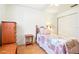 Inviting bedroom with a single bed, dresser, and closet, perfect for a cozy and organized space at 915 Sutherland Ct, Leesburg, FL 34788