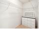 Organized walk-in closet featuring white wire shelving and drawers for efficient storage solutions at 915 Sutherland Ct, Leesburg, FL 34788