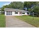 Well-maintained home with a long driveway, screened porch, and manicured lawn at 915 Sutherland Ct, Leesburg, FL 34788