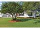 Inviting home with a large tree in the front yard offering shade and curb appeal at 915 Sutherland Ct, Leesburg, FL 34788