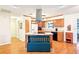 Kitchen features light wood cabinets, stainless hood and eat in kitchen bench at 915 Sutherland Ct, Leesburg, FL 34788