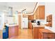 Kitchen featuring light wood cabinets and stainless steel appliances at 915 Sutherland Ct, Leesburg, FL 34788