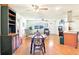 Open living room with hardwood floors, ceiling fans and an abundance of natural light at 915 Sutherland Ct, Leesburg, FL 34788
