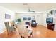 Bright living room featuring hardwood floors, comfortable furniture, and ample space at 915 Sutherland Ct, Leesburg, FL 34788