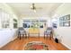 Bright sunroom with neutral paint and large windows providing lots of light at 915 Sutherland Ct, Leesburg, FL 34788