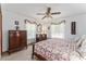 Comfortable bedroom featuring two dressers, two windows, and a cozy quilt on the bed at 10159 Se 174Th St, Summerfield, FL 34491