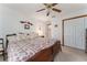 Bedroom with a large bed, wood trim, and bright natural light and double door closet at 10159 Se 174Th St, Summerfield, FL 34491