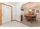 Warm dining area featuring a round wooden table with chairs and a decorative display case at 10159 Se 174Th St, Summerfield, FL 34491