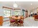Dining area featuring wood table set near windows, creating a comfortable atmosphere for dining and gathering at 10159 Se 174Th St, Summerfield, FL 34491